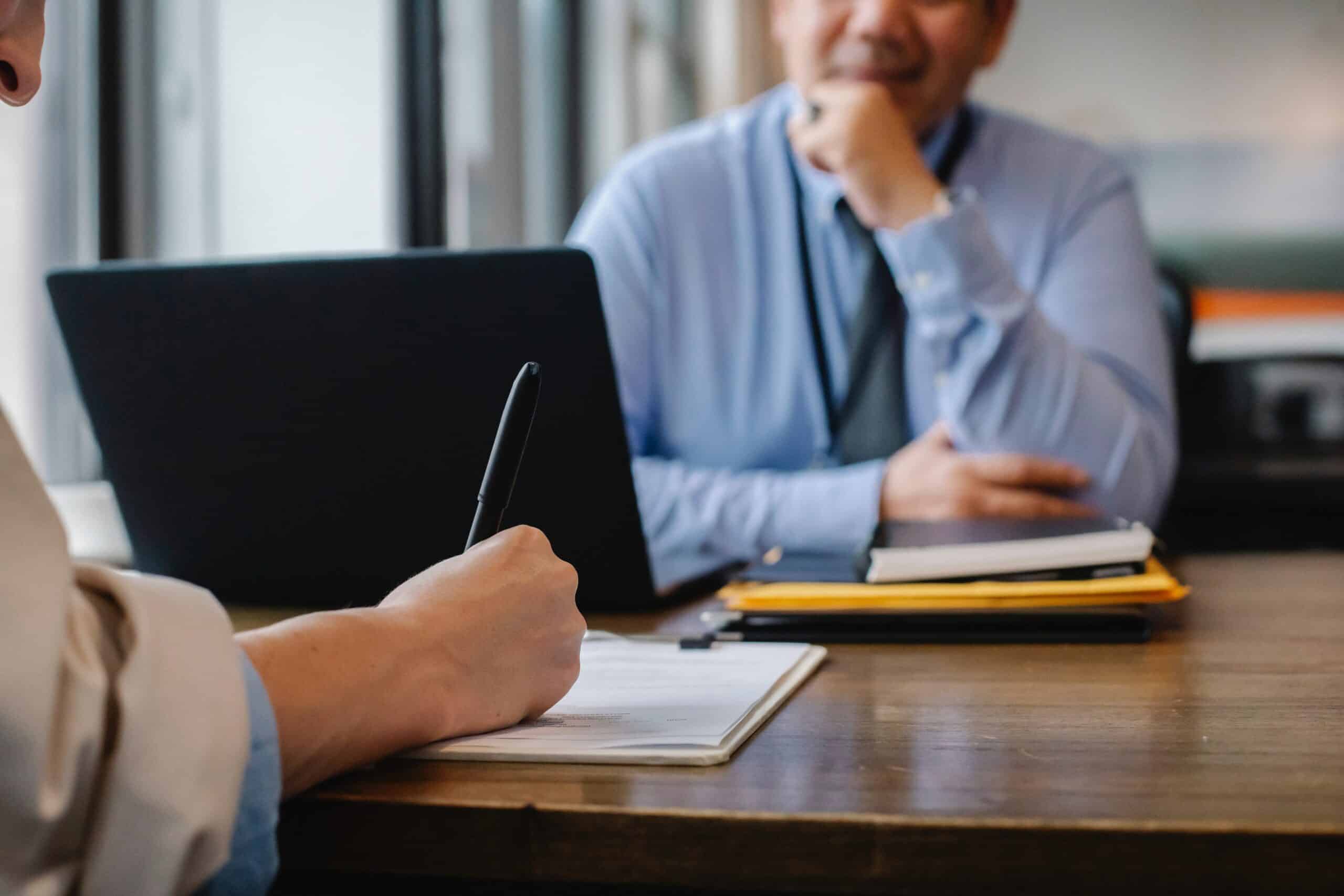 Two people across from each other at an office desk